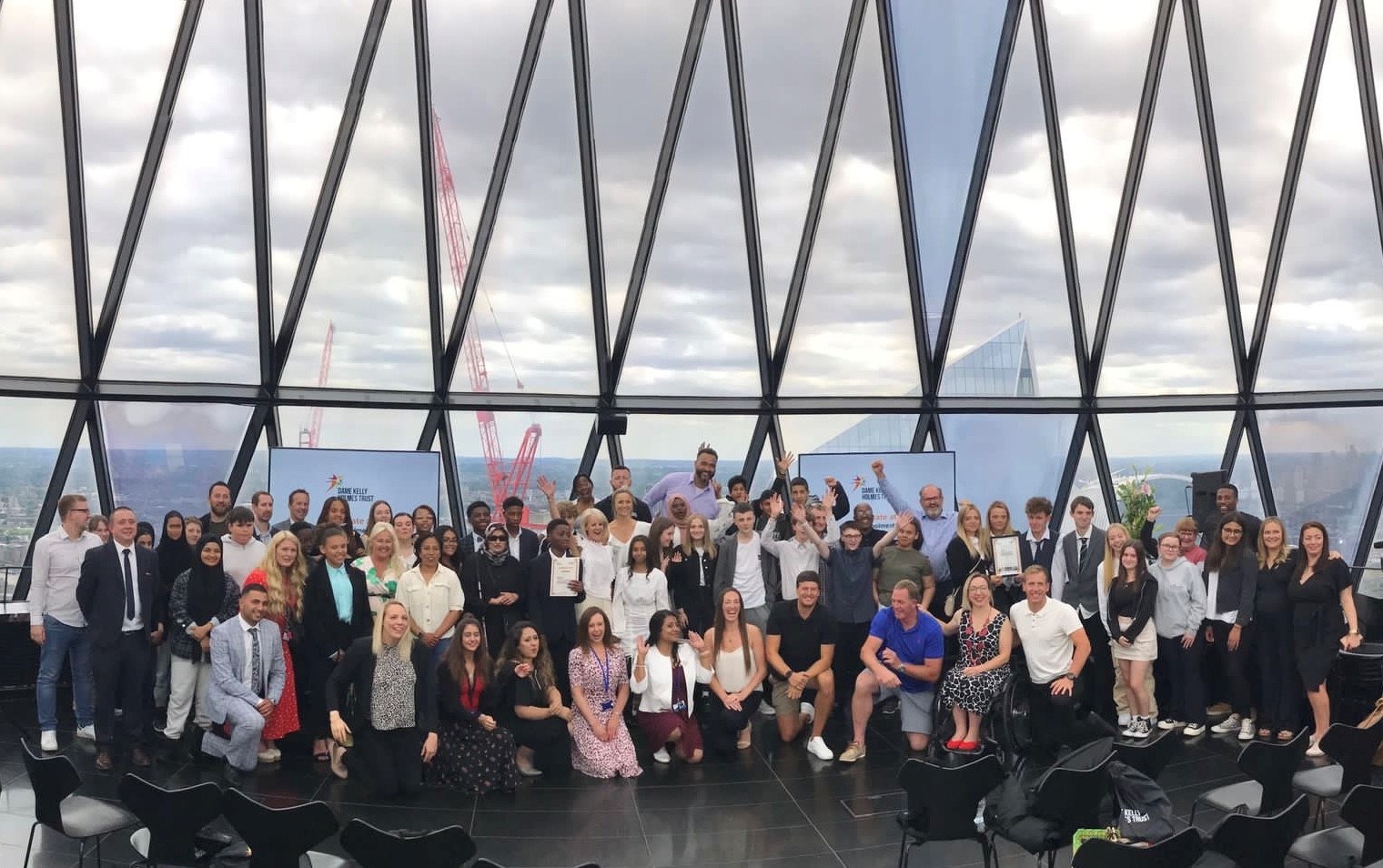 AQA Unlocking Potential graduates on the top floor of the Gherkin, a London skyscraper.